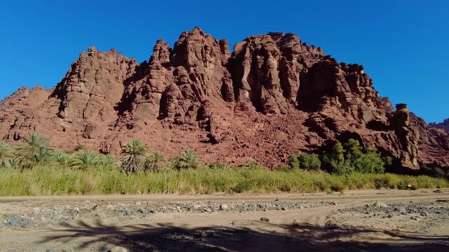 Al-Disah, Saudi Arabia: Panoramic footage of the stunning wadi Al-Disah canyon famous for its red rock and palm tree near Tabuk in the desert of Saudi Arabia. 