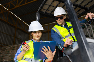 Professional construction workers coordinating material logistics and safety