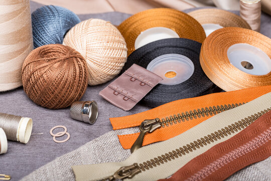 Crafting and sewing notions with thread, zippers, and thimble - Powered by Adobe