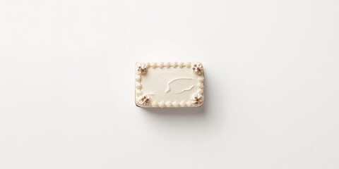 Top-down view of a rectangular cake on a plain white surface for presentation purposes