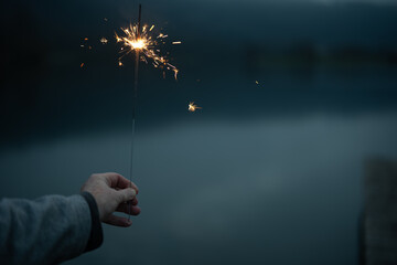 Burning sparkler in the evening duskBurning sparkler in the evening dusk