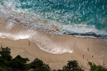 Aerial Top-Down View of a Beach with Gentle White Foamy Waves High quality photo