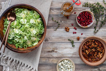 Shredded Brussels sprouts with ingredients to make a fresh salad.