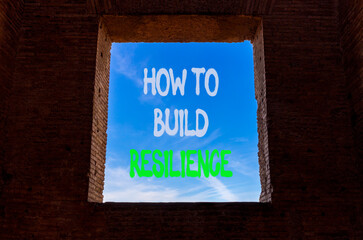 Obraz premium How to build resilience symbol. Concept words How to build resilience on beautiful window in ancient brick wall. Beautiful blue sky background. Business how to build resilience concept. Copy space.