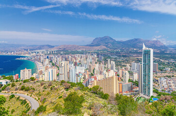 Benidorm panorama, aerial view of Benidorm city centre coastline, buildings on Costa Blanca coast Mediterranean Sea and Puig Campana mountain Sierra Cortina in summer day, Valencian Community, Spain