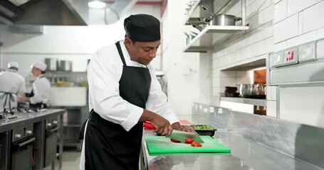 Chef, man or cut vegetables in restaurant for meal prep, culinary process or catering in food industry. Hospitality staff, cook and chop tomatoes in kitchen for fresh ingredients, cuisine and recipe