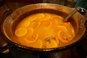 Hot mulled wine with lemon and with other citrus fruits