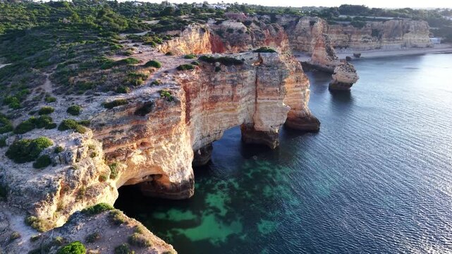 Portugal algarve aerial view of coastal cliffs and turquoise water at sunrise or sunset