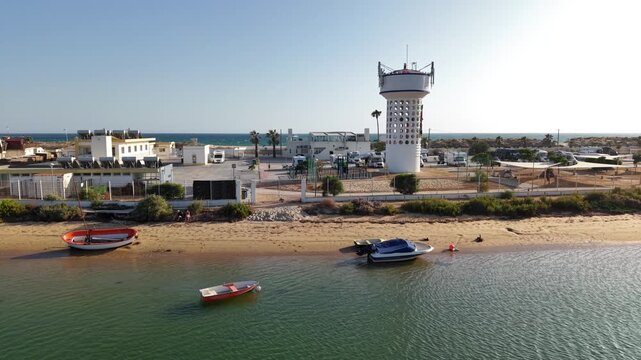 Aerial view of Olhao cityscape and waterfront Algarve Portugal with boats on the sand near the Ria Formosa park