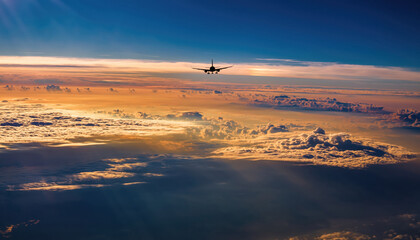 Obraz premium Passenger Aircraft Above Scenic Clouds at Golden Hour. Epic Sky, Journey, Horizon, Aerial Transport.