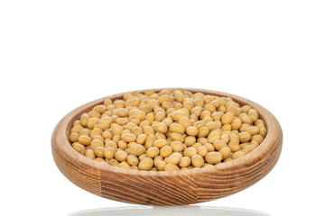 Soybeans with kitchen utensils isolated on white background, close-up.