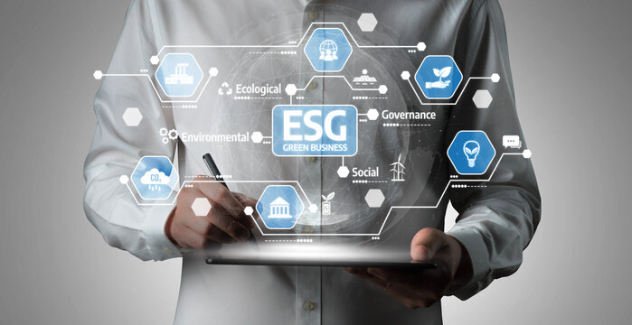 Business Professional Holding Tablet with Digital ESG Icons Representing Environmental, Social, and Governance Principles in Modern Enterprise Applications. Tessel. - Powered by Adobe