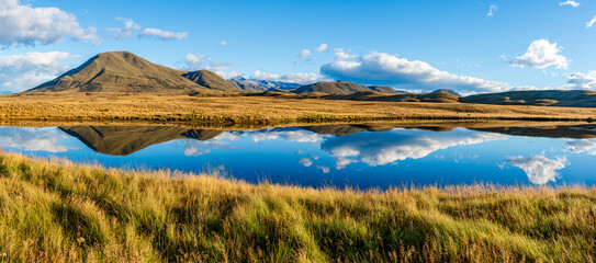 Fototapeta premium Landscape of Mount Guy reflected in the waters of Lake Clearwater on the South island of New Zealand; nature landscape of alpine mountain range at Ashburton Lakes, Hakatere conservation area