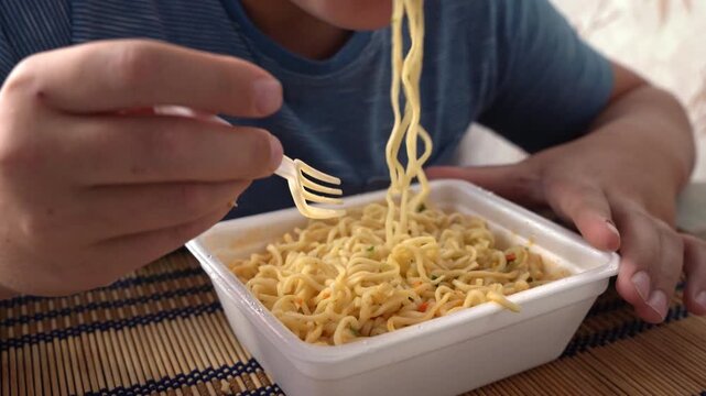Enjoying a bowl of noodles at home during lunchtime on a weekday