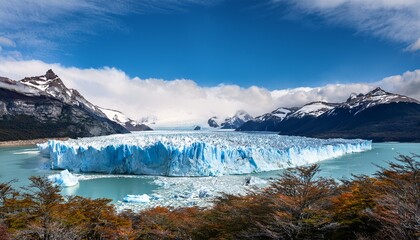 Majestic Perito Moreno Glacier With Snow Capped Mountains In Patagonia Argentina Vivid Blue Tones Of The Ice Contrast With The Dark Slopes Highlighting The Raw Beauty Of Nature