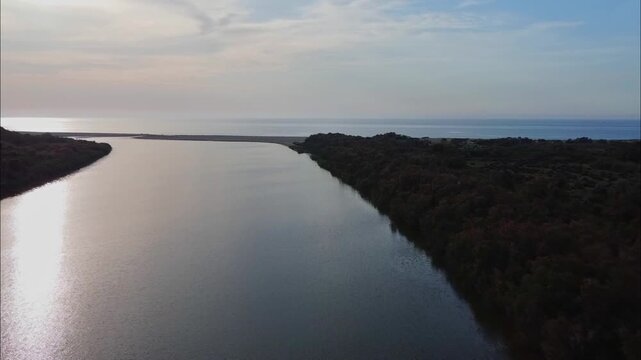 Aerial View of river, Beautiful Aerial View of African Jungles forest and River, Landscape in aerial drone shot. Adove calm tranquil river in Jijel Algeria North Africa, River and green fores trees.