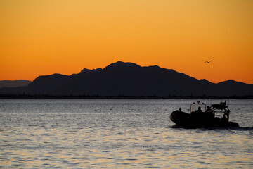Motorboat sailing at sunset in Santa Pola coast