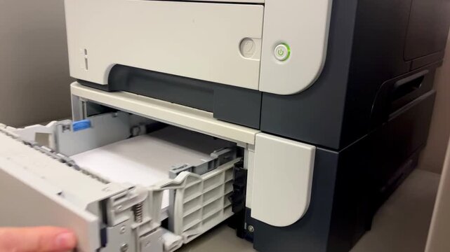 Close-Up Video of Reloading Paper in an Office Printer