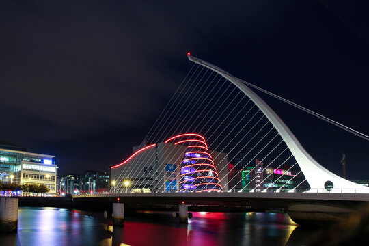 Dublin, Ireland - September 09. 2018: Samuel Beckett Bridge or Harp Bridge -a cable-stayed bridge by architect Santiago Calatrava with Barrel shaped Dublin Convention Center (The CCD)