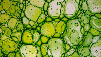 Vibrant macro shot of liquid bubbles and organic textures in shades of yellow and green. The intricate design evokes themes of microbiology, cellular structures, and scientific research. High-quality 