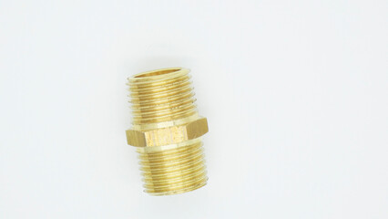 Brass pipe fitting on a plain background with visible threads and a hexagonal section for gripping