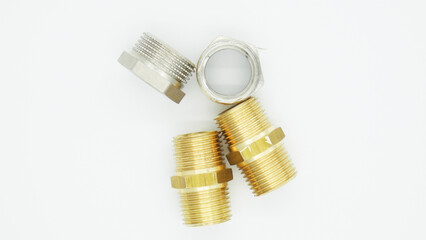 Metal fittings of different sizes and shapes arranged on a light background for assembly and plumbing tasks