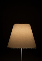 A comforting, fuzzy fabric lamp emitting a gentle, diffused light, highlighting the soft texture of the material for a relaxing home atmosphere ,product ,evening ,Plush