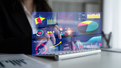 A business professional engages with a futuristic digital interface showcasing vibrant graphs and performance metrics in a sleek office environment. Impute