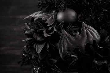 Gothmas. Gothic Holiday Decor. Dark festive wreath with black bats and flowers creating a...