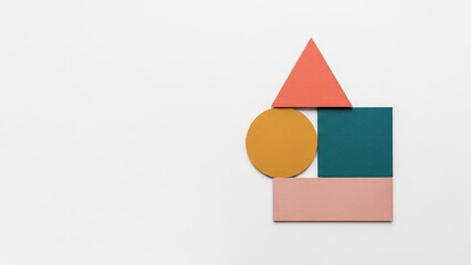 A minimalist composition of geometric shapes creates an abstract house structure on a white background