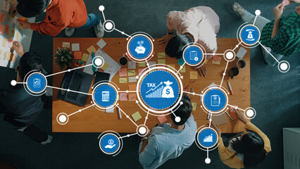 A diverse team of professionals collaborates in a modern office space, utilizing sticky notes and charts to strategize and plan for effective tax management and financial analysis. Amity