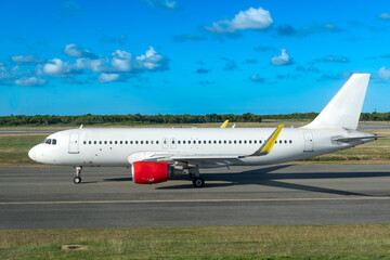 A side view of a passenger plane on the tarmac at Punta Cana airport, ready for departure.