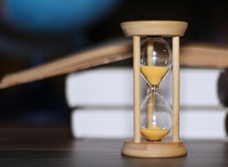 Globe hourglass and books symbols of time adventure knowledge	
