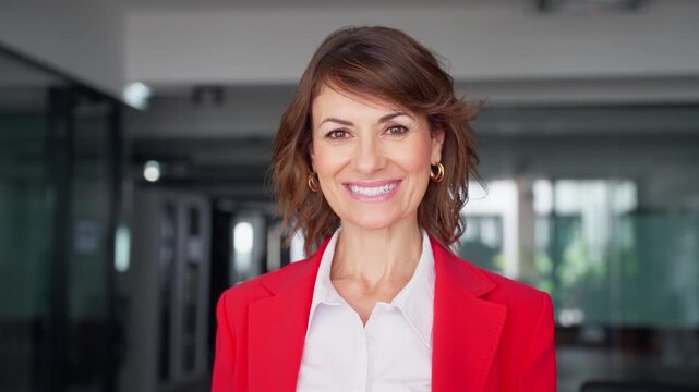 Headshot close up portrait of latin hispanic confident mature good looking middle age leader, ceo female businesswoman on blur office background. Gorgeous beautiful business woman smiling at camera.