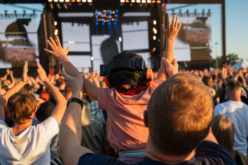 Applause of a boy with headphones during music concert