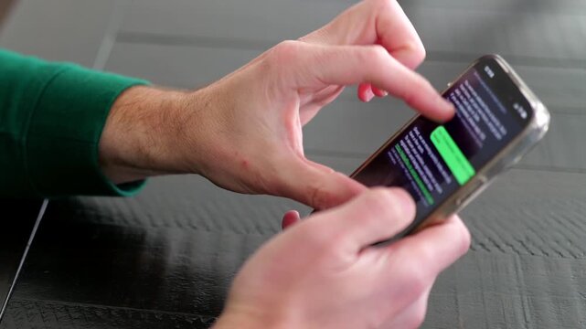 Middle Aged Man Receives an Attractive Remote Job Opportunity - SMS Text Scam to Credential Data Harvesting - Cybersecurity Education Concept