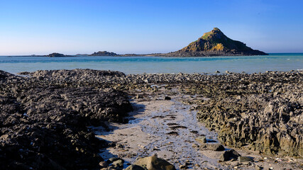 Rocky coast in low tide at Pleneuf Val Andre with the Verdelet islet. Pleneuf Val Andre is a commune in the C&ocirc;tes-d'Armor department of Brittany in northwestern France