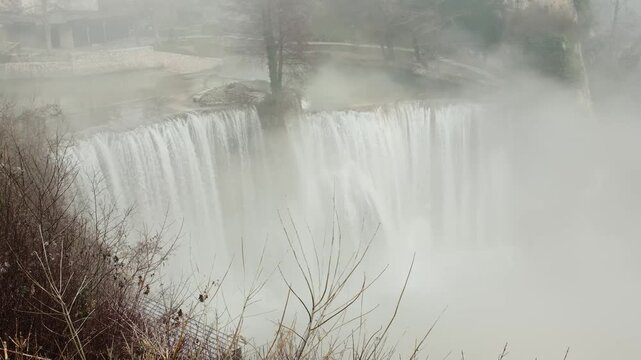 Plivski Vodopad waterfall in Bosnia and Herzegovina with strong water flow and rising mist. Dramatic natural landmark showing raw energy, motion and wild landscape atmosphere. Horizontal 4k footage