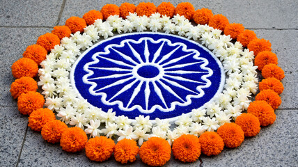Ashoka Chakra surrounded by two concentric rings of flowers  