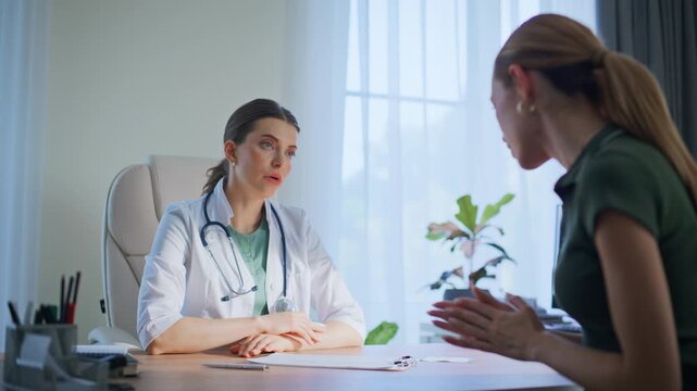 Woman patient talking doctor in clinic. Therapist consulting polyclinic visitor