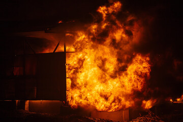 Exploding and burning building. Big blaze at night