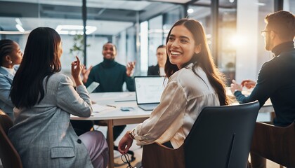 Cheerful young female marketing manager smiling happily during a dynamic team meeting in a modern glass office, concept for corporate success, collaborative networking and professional communication