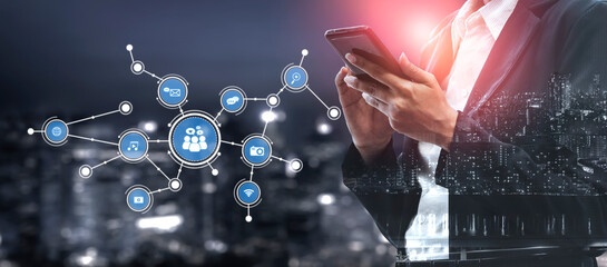 A business professional engages with a smartphone against a city skyline, showcasing a network of digital icons that represent connectivity and communication trends. Tessel