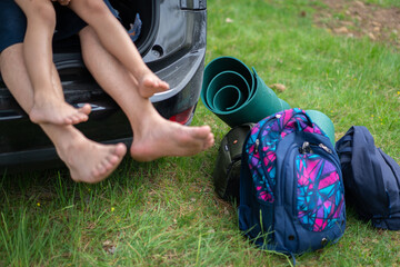 Close Up of Family Feet Resting in Open Car Trunk During Road Trip. High quality photo