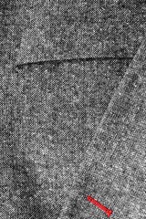 Detail of a pocket of a gray woolen coat close up background