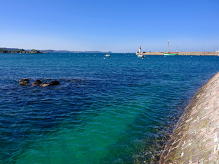 Sea and lighthouse in the background at Erquy, a commune in the Cotes d Armor department of Brittany in northwestern France on the cote de Penthievre
