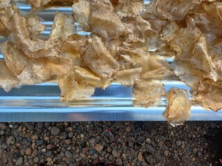 Drying raw Jengkol crackers in The Yard