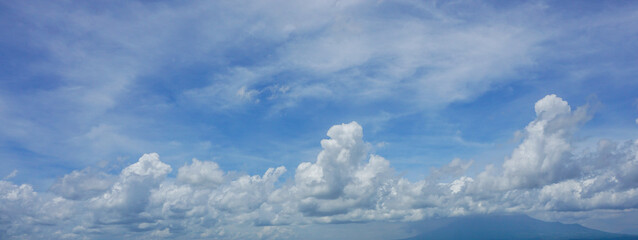 Beautiful blue sky with fluffy white clouds on a sunny day
