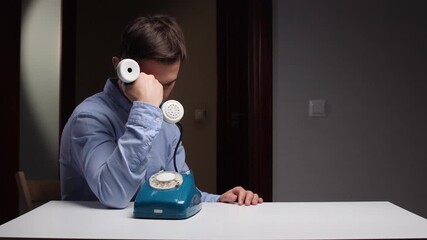Gentleman listens carefully to sorrow, Serious man processes mournful information via old telephone device, Man attentively listens and understands distressing news using antique phone equipment