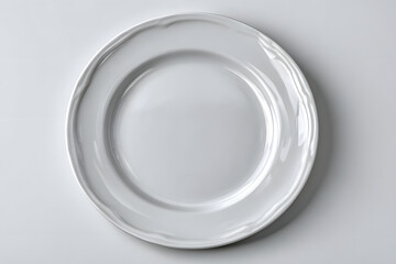 Empty ceramic round plate isolated on white background. View from above.